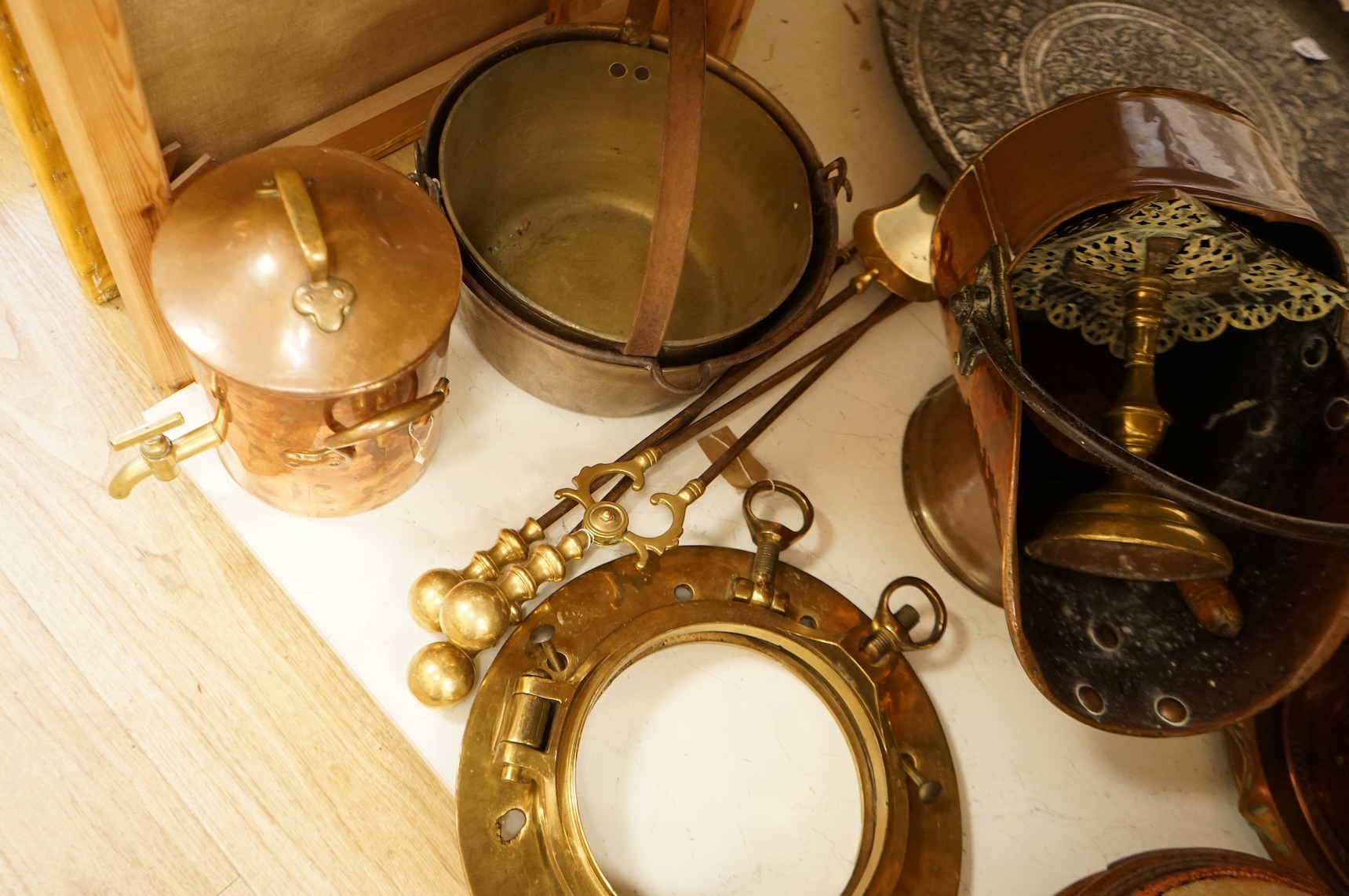 Assorted Victorian and later copper and brassware including two ships portholes, copper kettle pots, etc (16). Large porthole 36cm diameter